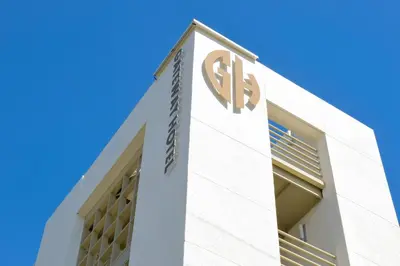a white building with a sign on the side of it at Gateway Hotel Santa Monica in Los Angeles