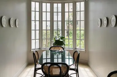 a dining room with a table and chairs and a window at Palihotel Westwood Village - West Beverly Hills in Los Angeles
