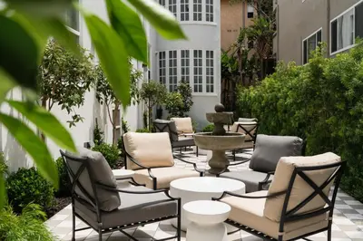 a row of chairs and a fountain on a patio at Palihotel Westwood Village - West Beverly Hills in Los Angeles