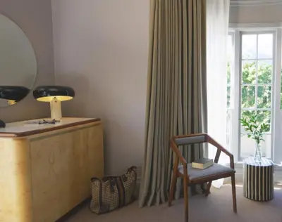 a living room with a chair and a window at Palihotel Westwood Village - West Beverly Hills in Los Angeles