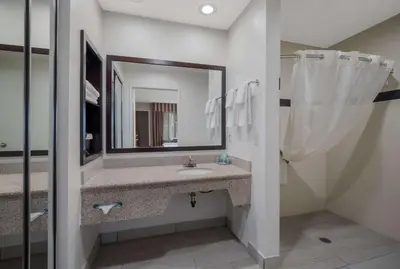 a bathroom with a sink and a mirror at Best Western Norwalk Inn in Norwalk