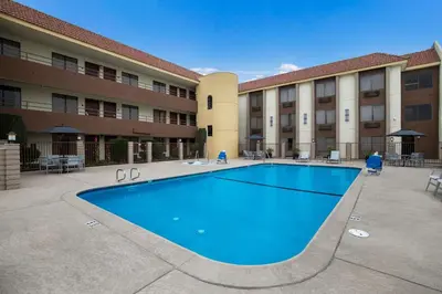 a large swimming pool in front of a building at Best Western Norwalk Inn in Norwalk