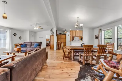 a living room with a couch and a table at Country Club Chalet in Big Bear City