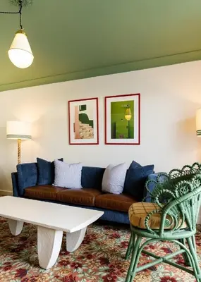 a living room with a couch and a coffee table at Palihouse West Hollywood at Beverly Hills in Los Angeles