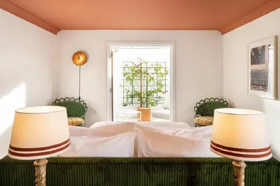 a bedroom with a bed with two lamps at Palihouse West Hollywood at Beverly Hills in Los Angeles