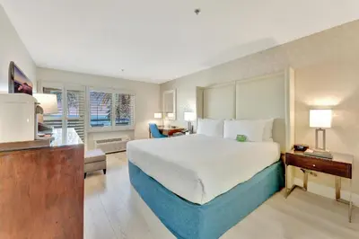 a hotel room with a large bed and a kitchen at Ocean View Hotel in Los Angeles
