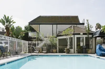 a swimming pool in front of a house at Alamo Inn and Suites - Convention Center in Anaheim