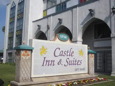 a sign for a castle inn and suites in front of a building at Castle Inn and Suites Anaheim in Anaheim