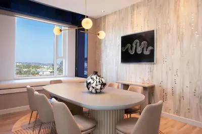 a dining room with a table and chairs and a window at W Hollywood in Los Angeles