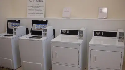 four machines are lined up on a shelf in a store at Holiday Inn El Monte - Los Angeles by IHG in El Monte