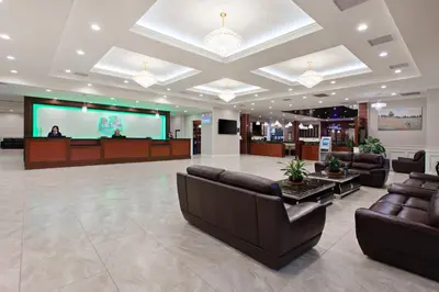 a lobby with leather couches and a projection screen at Holiday Inn El Monte - Los Angeles by IHG in El Monte