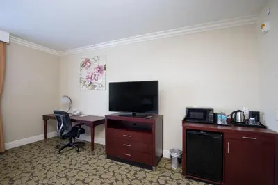 a hotel room with a desk with a television and a computer at Holiday Inn El Monte - Los Angeles by IHG in El Monte