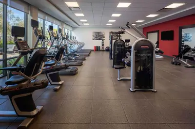 a gym with a row of treadms and cardio machines at Homewood Suites By Hilton Long Beach Airport in Long Beach