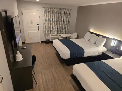 a hotel room with two beds and a flat screen tv at Motel 6 Los Angeles, CA - Downtown in Los Angeles