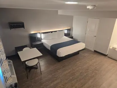 a hotel room with a bed and a table and a desk at Motel 6 Los Angeles, CA - Downtown in Los Angeles