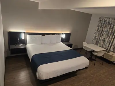 a hotel room with a large bed and a desk at Motel 6 Los Angeles, CA - Downtown in Los Angeles