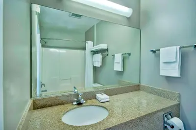 a bathroom with a sink and a mirror and towels at Studio 6-Bakersfield, CA in Bakersfield
