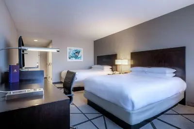 a hotel room with two beds and a desk at DoubleTree by Hilton Los Angeles Norwalk in Norwalk
