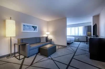a hotel room with a couch and a bed at DoubleTree by Hilton Los Angeles Norwalk in Norwalk