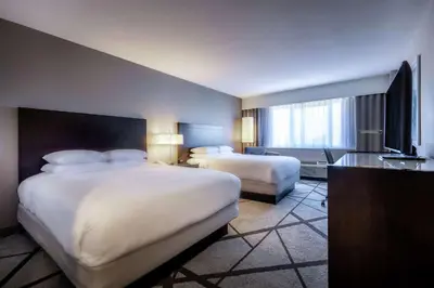 a hotel room with two beds and a television at DoubleTree by Hilton Los Angeles Norwalk in Norwalk