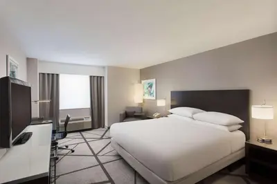 a hotel room with a large bed and a television at DoubleTree by Hilton Los Angeles Norwalk in Norwalk