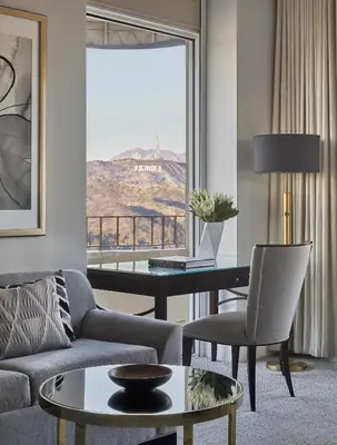 a living room with a couch and a table at Four Seasons Hotel Los Angeles at Beverly Hills in Los Angeles