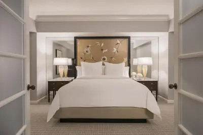 a bedroom with a large white bed and two night stands at Four Seasons Hotel Los Angeles at Beverly Hills in Los Angeles
