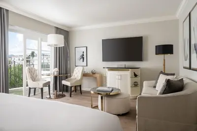 a living room with a couch and a tv at Four Seasons Hotel Los Angeles at Beverly Hills in Los Angeles