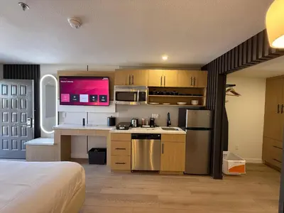 a room with a kitchen with a bed and a kitchen at MainStay Suites Victorville - Hesperia in Victorville