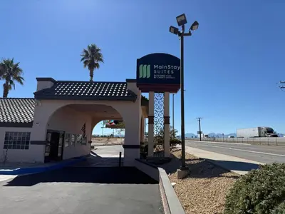 a gas station with a sign in front of it at MainStay Suites Victorville - Hesperia in Victorville