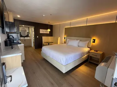 a hotel room with a bed and a television at MainStay Suites Victorville - Hesperia in Victorville