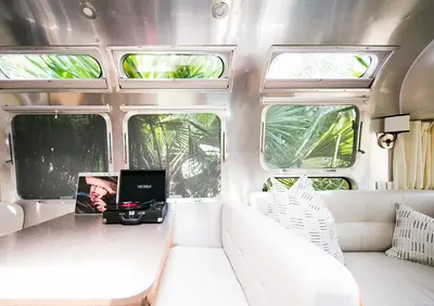 a living room with a couch and a laptop on a table at Caravan Outpost in Ojai