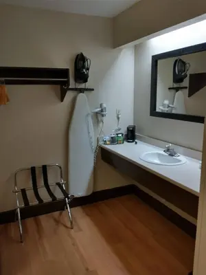 a bathroom with a sink and a mirror at Red Roof Inn Santa Ana in Santa Ana