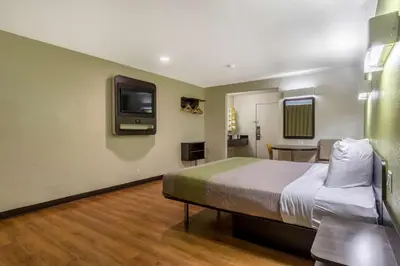 a bedroom with a bed and a tv on the wall at Motel 6-Redlands, CA in Redlands