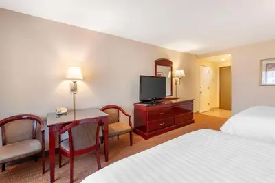 a hotel room with a bed and a television at Best Western Plus West Covina Inn in West Covina
