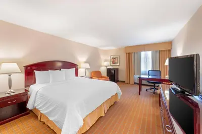 a hotel room with a bed and a flat screen tv at Best Western Plus West Covina Inn in West Covina