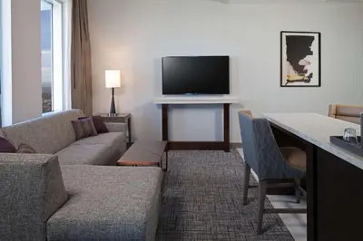 a living room with a couch and a television at H Hotel Los Angeles, Curio Collection By Hilton in Los Angeles