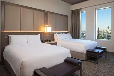 a hotel room with two beds and a window at H Hotel Los Angeles, Curio Collection By Hilton in Los Angeles