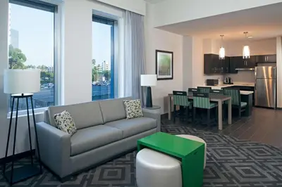 a living room with a couch and a dining room at Homewood Suites By Hilton Los Angeles International Airport in Los Angeles