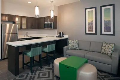 a kitchen and living room with a couch and a table at Homewood Suites By Hilton Los Angeles International Airport in Los Angeles
