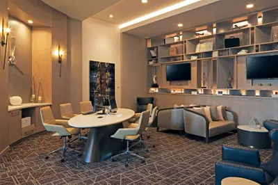 a waiting room with a table and chairs at Homewood Suites By Hilton Los Angeles International Airport in Los Angeles