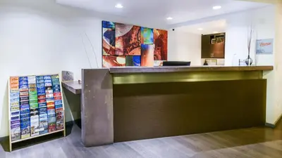 a bar in a room with a counter top at The Tangerine - a Burbank Hotel in Burbank