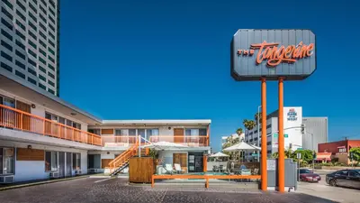 a sign for a tarantula restaurant in front of a building at The Tangerine - a Burbank Hotel in Burbank