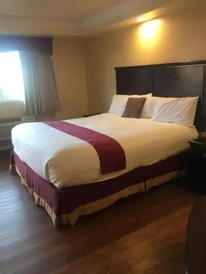 a bed in a hotel room with a large bed at Budget Lodge San Bernardino in San Bernardino