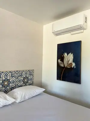 a bedroom with a bed with a flower painting on the wall at Anaheim Maingate Inn in Anaheim