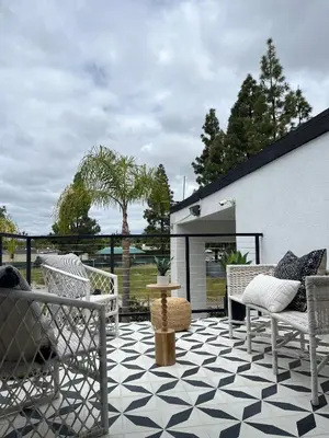 a patio with chairs and a table on a checkered floor at Anaheim Maingate Inn in Anaheim