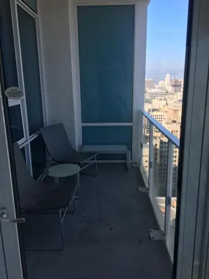 a room with chairs and a view of a city at Luxurious Highrise 2b 2b Apartment Heart Of Downtown LA in Los Angeles