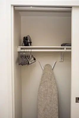 a tie hanging on a rack in a closet at Luxurious Highrise 2b 2b Apartment Heart Of Downtown LA in Los Angeles