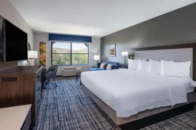a hotel room with a bed and a flat screen tv at Hampton Inn & Suites Agoura Hills in Agoura Hills