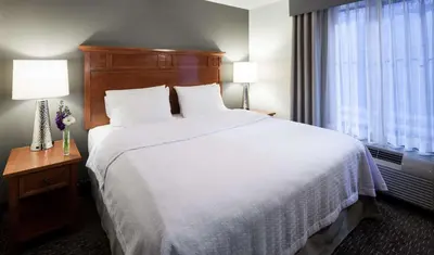 a hotel room with a large bed and a window at Homewood Suites by Hilton Agoura Hills in Agoura Hills